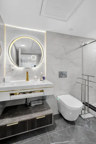 a bathroom with a toilet and a mirror