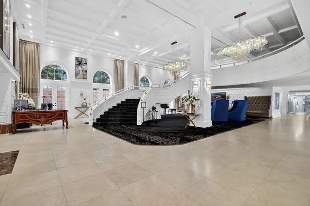 a living room with furniture and a chandelier