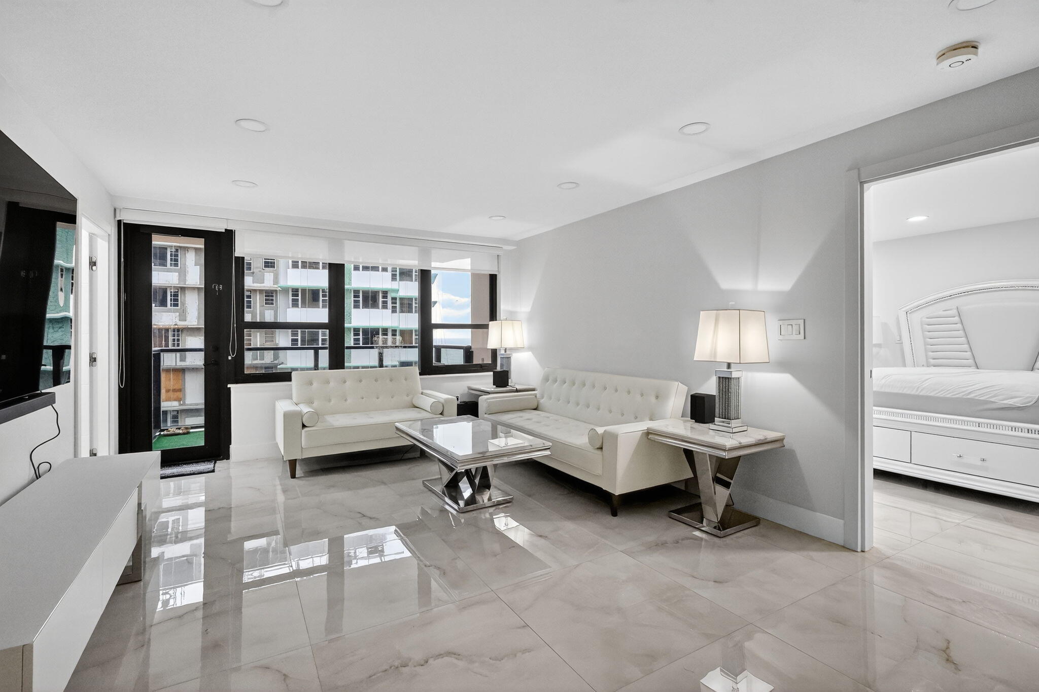 5225 Collins Avenue, Unit 1408 Miami Beach, FL 33140 - Photo 3 of 37 a living room with furniture window and a table