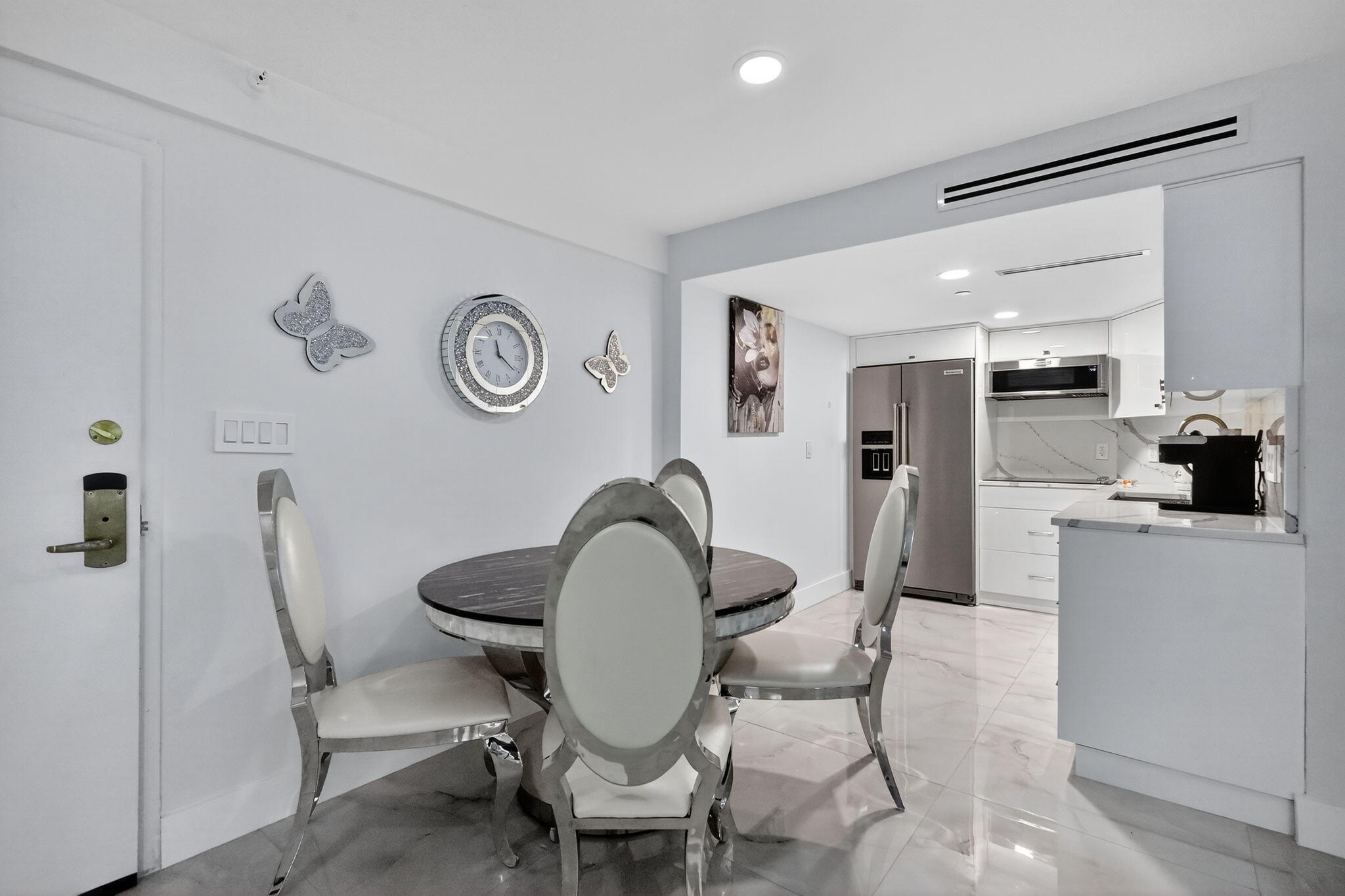 5225 Collins Avenue, Unit 1408 Miami Beach, FL 33140 - Photo 8 of 37 a living room with furniture a clock and a refrigerator