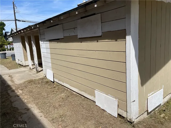 a view of a house with a wooden fence