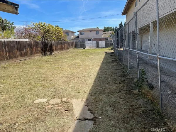 a view of a backyard with large trees