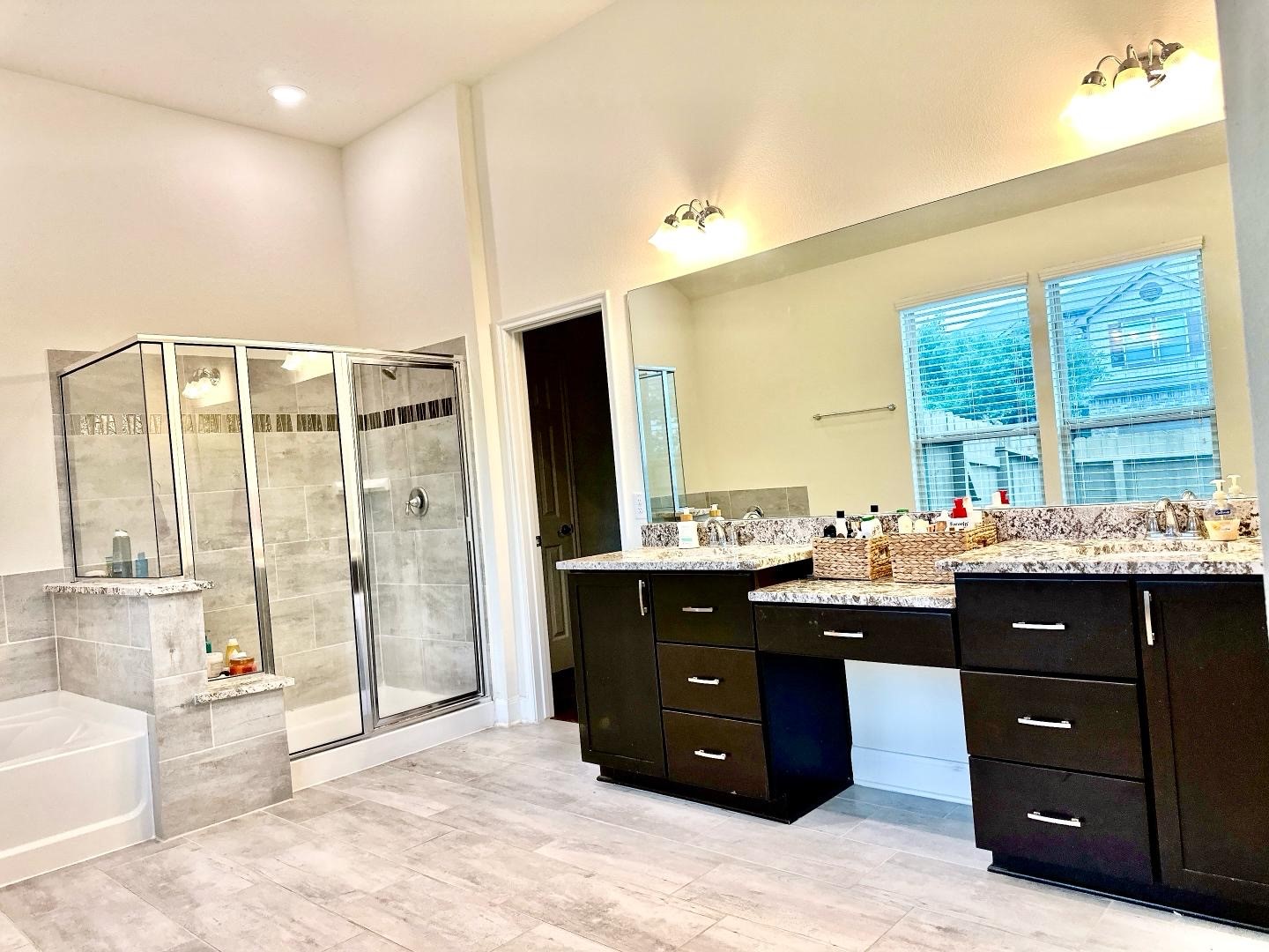1110 Penny Ranch Lane Katy, TX 77494 - Photo 22 of 31 a spacious bathroom with a granite countertop sink and a bathtub