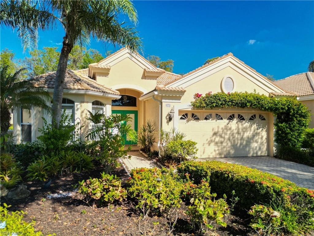 9190 Troon Lakes Drive Naples, FL 34109 - Photo 2 of 50 a view of a house with a big yard and potted plants