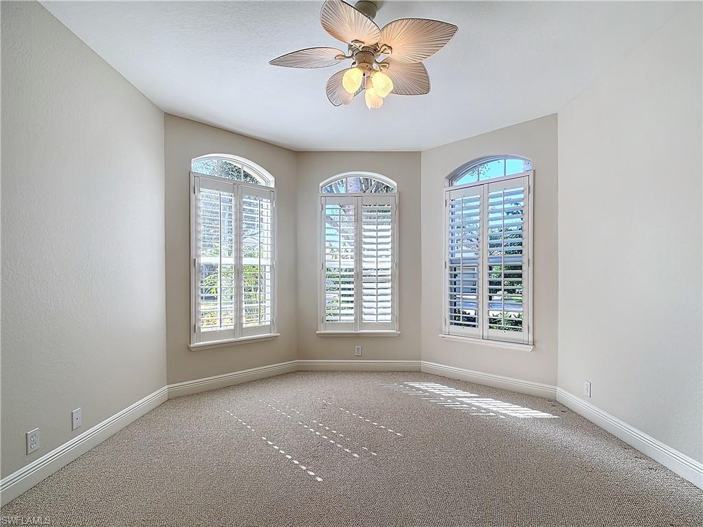 9190 Troon Lakes Drive Naples, FL 34109 - Photo 21 of 50 an empty room with a window and a fan