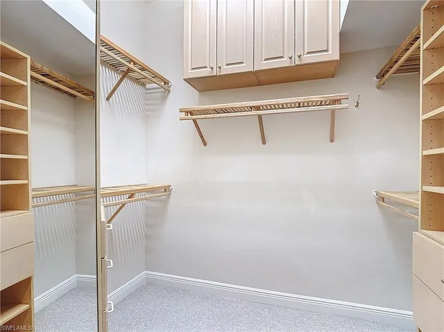 a view of walk in closet with empty racks