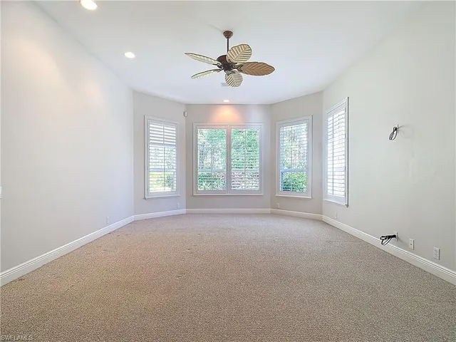 a view of a livingroom with a ceiling fan and window