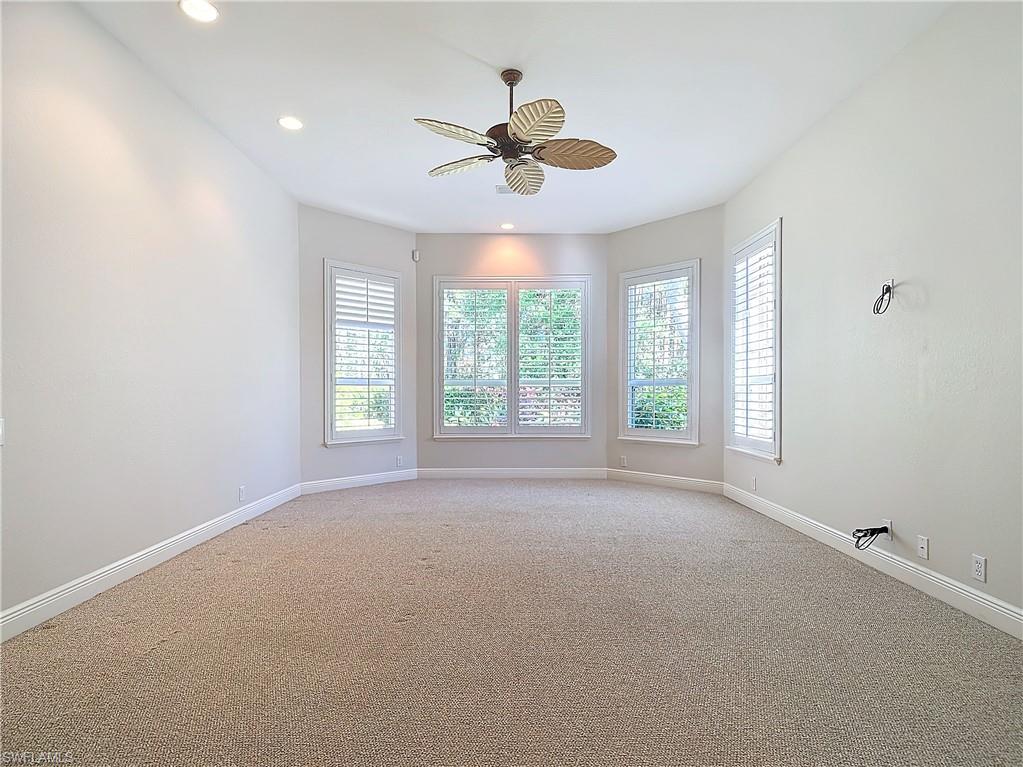9190 Troon Lakes Drive Naples, FL 34109 - Photo 30 of 50 a view of a livingroom with a ceiling fan and window