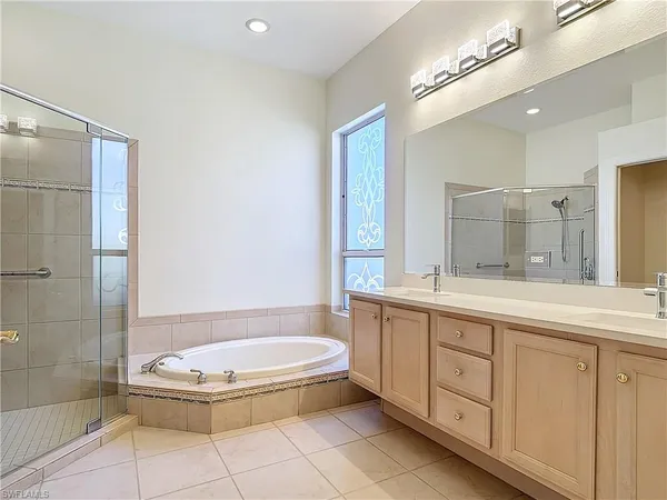 a bathroom with a granite countertop sink toilet a mirror and shower