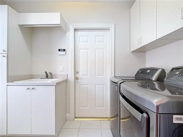 a kitchen with a sink cabinets and appliances