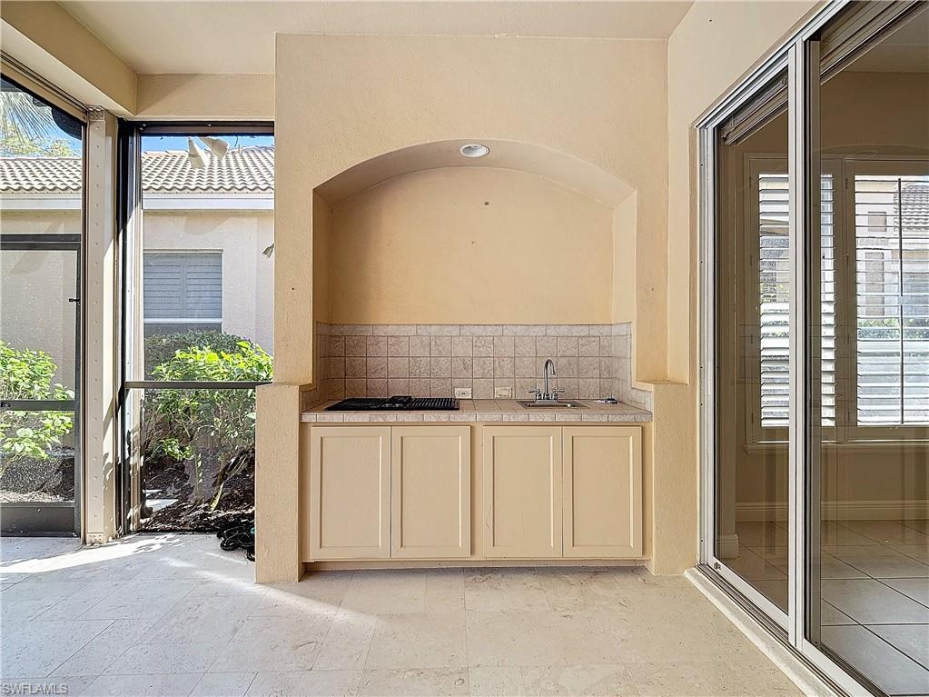 9190 Troon Lakes Drive Naples, FL 34109 - Photo 42 of 50 a spacious bathroom with a granite countertop sink and a mirror
