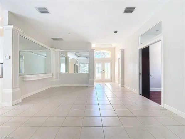 a view of an empty room with glass door