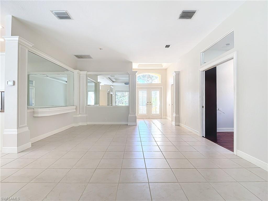9190 Troon Lakes Drive Naples, FL 34109 - Photo 7 of 50 a view of an empty room with glass door