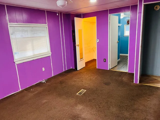 a view of an empty room with closet