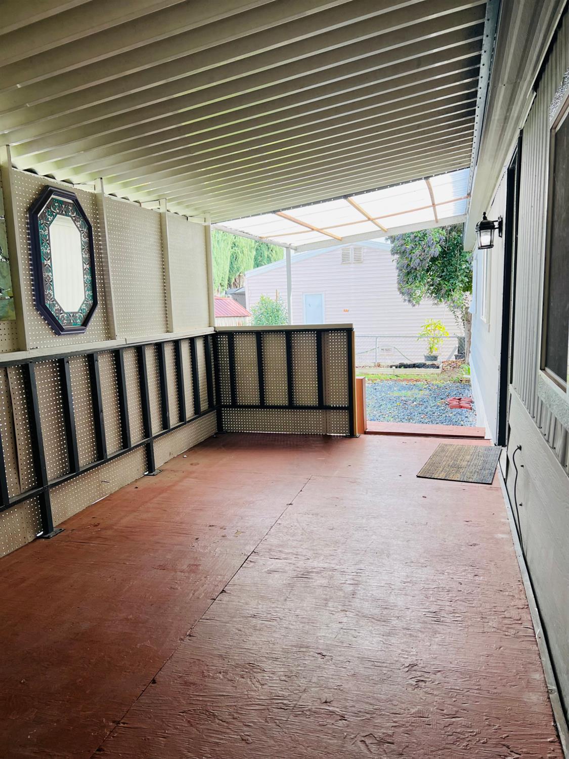 3950 Mack Road, Unit 175 Sacramento, CA 95823 - Photo 18 of 19 a view of a porch with furniture and front door