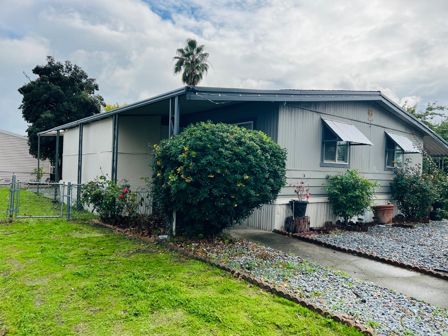 3950 Mack Road, Unit 175 Sacramento, CA 95823 - Photo 3 of 19 a front view of a house with garden