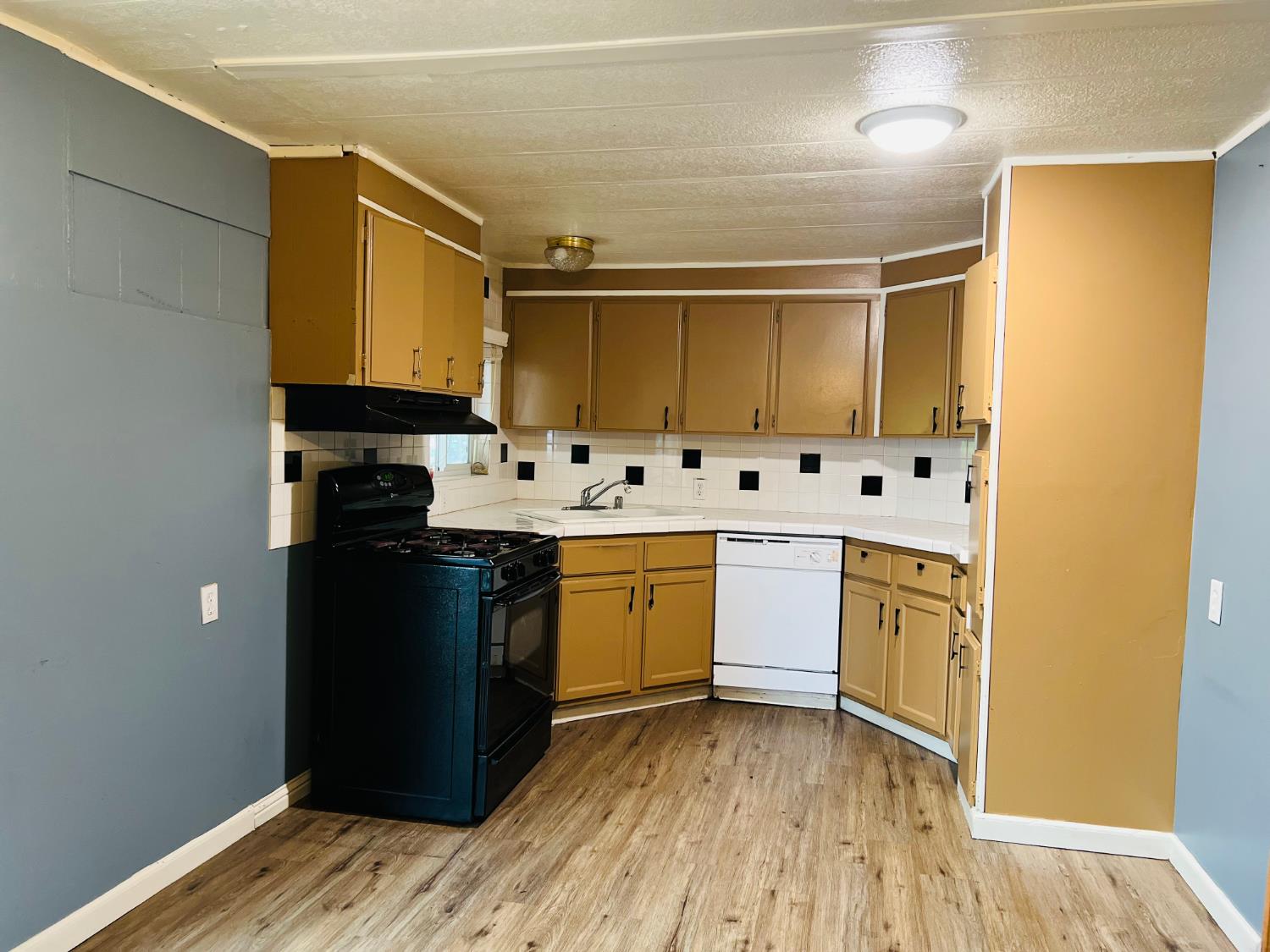 3950 Mack Road, Unit 175 Sacramento, CA 95823 - Photo 5 of 19 a kitchen with stainless steel appliances a sink a stove a refrigerator and cabinets