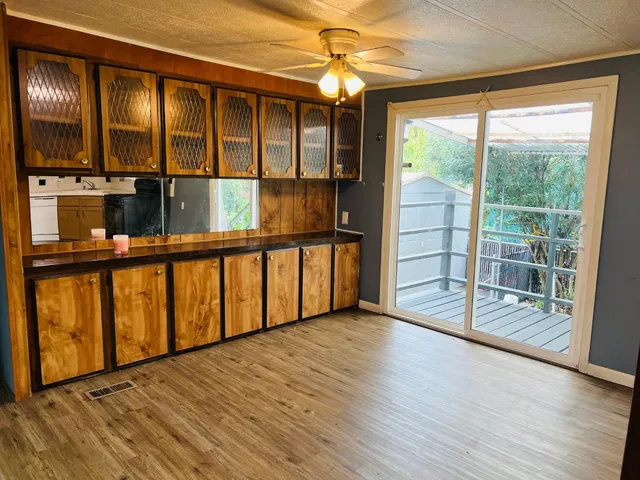 a view of a room with wooden floor and windows