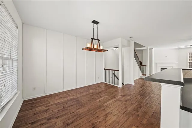 a kitchen with granite countertop a refrigerator and a sink
