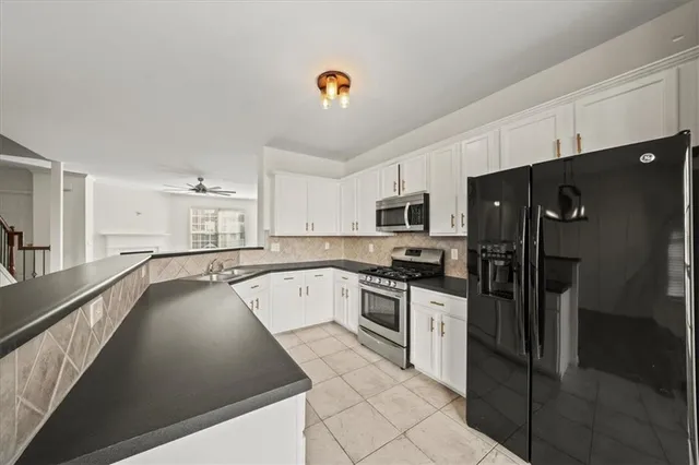 a kitchen with granite countertop a sink and a stove top oven