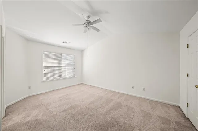 a spacious bathroom with a toilet sink and mirror