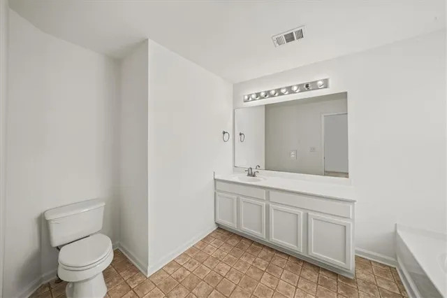 a bathroom with a bathtub shower and toilet
