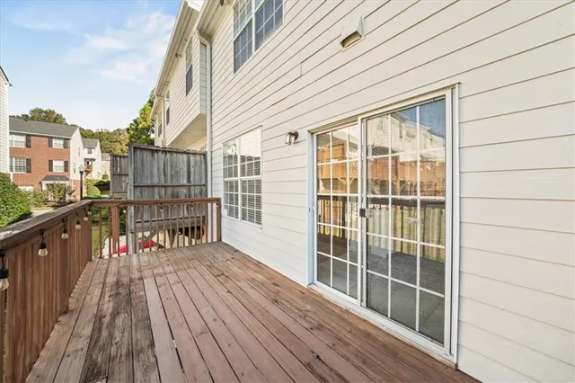 a view of a balcony with wooden floor and fence