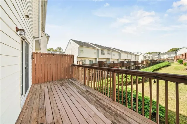 a view of a porch with furniture and a yard