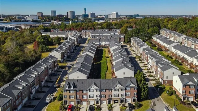a view of a city with lush green forest