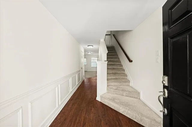 a view of entryway and hall with wooden floor