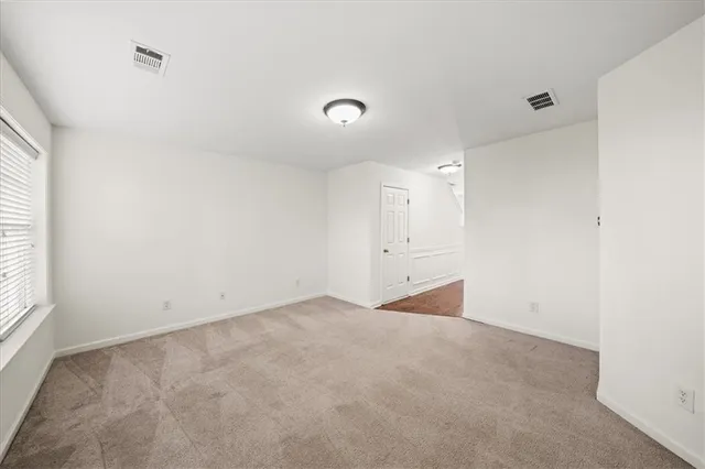 an empty room with a empty space and windows