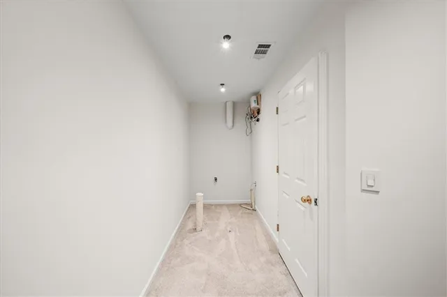 a view of a hallway with white walls
