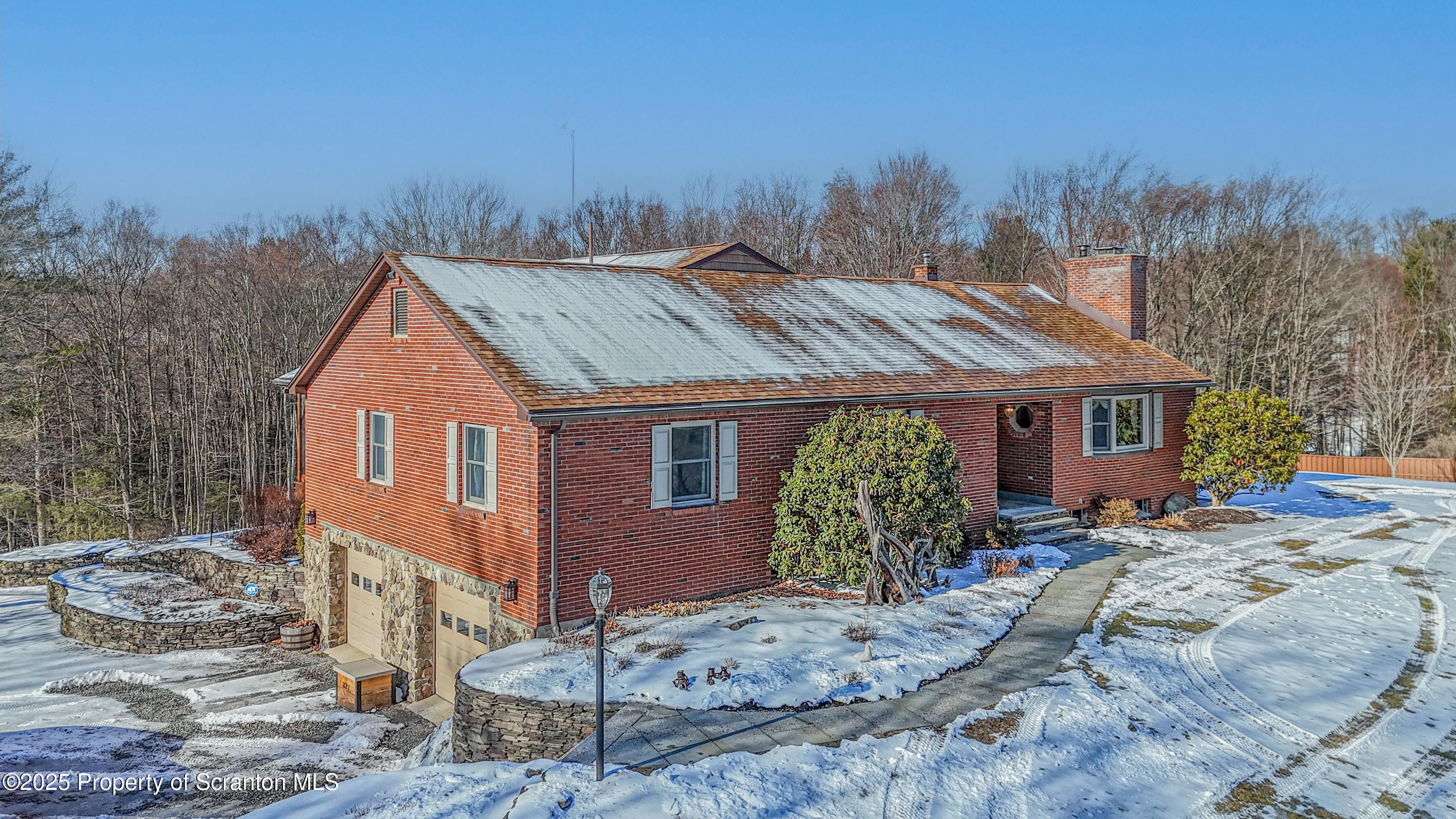 a view of a house with a tree in the background