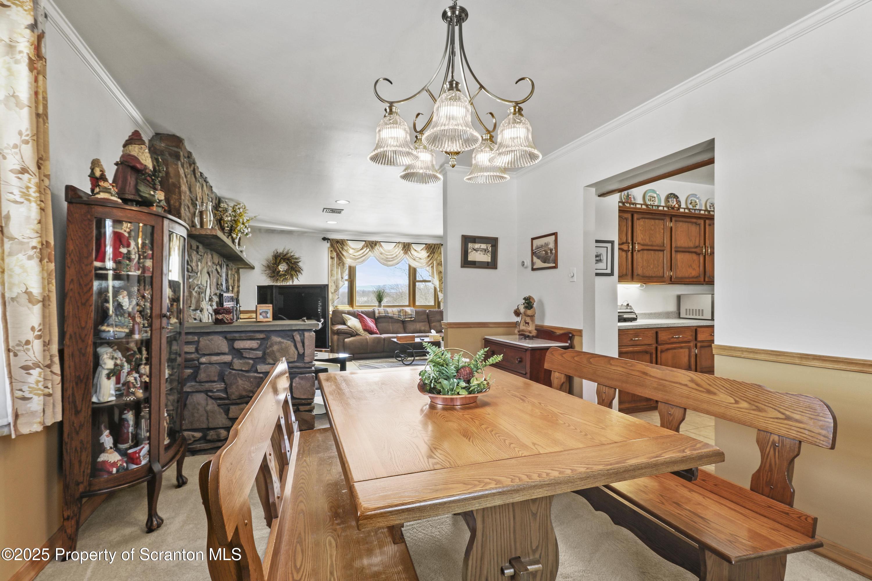 337 Ross Road Dalton, PA 18414 - Photo 13 of 45 a view of a dining room with furniture and a chandelier