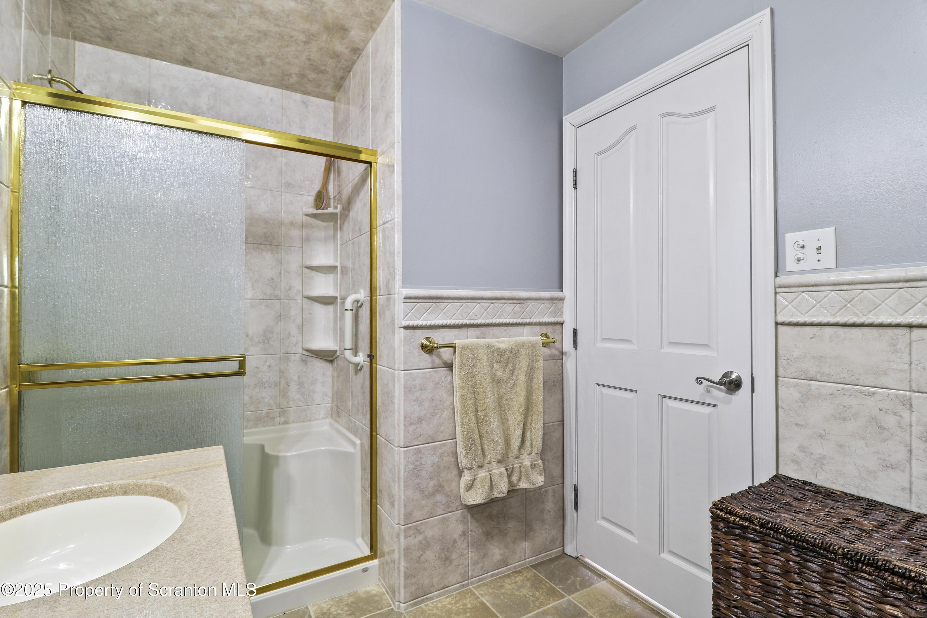 337 Ross Road Dalton, PA 18414 - Photo 17 of 45 a bathroom with a granite countertop shower and a sink