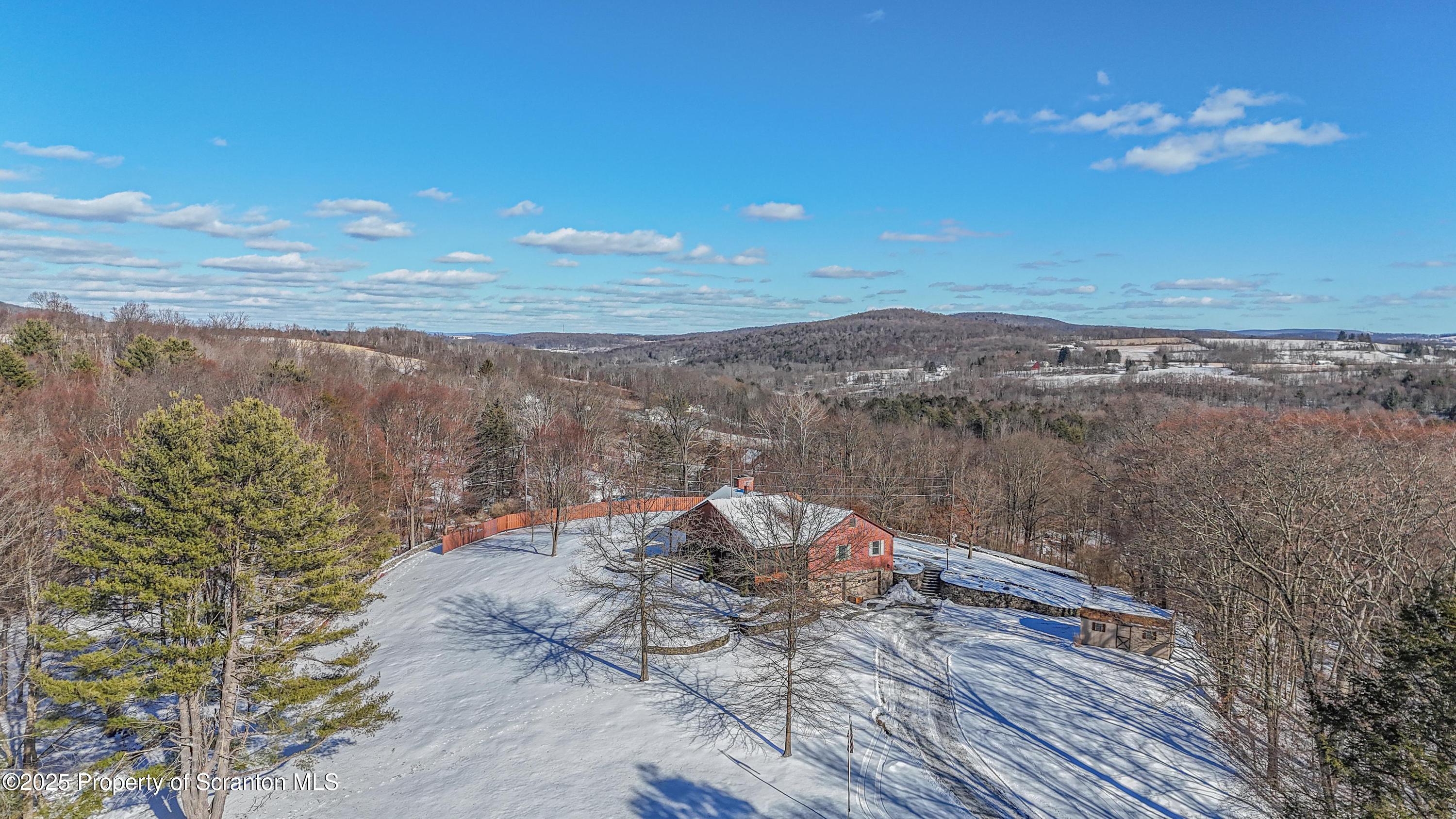 337 Ross Road Dalton, PA 18414 - Photo 2 of 45 a view of a lake with a mountain