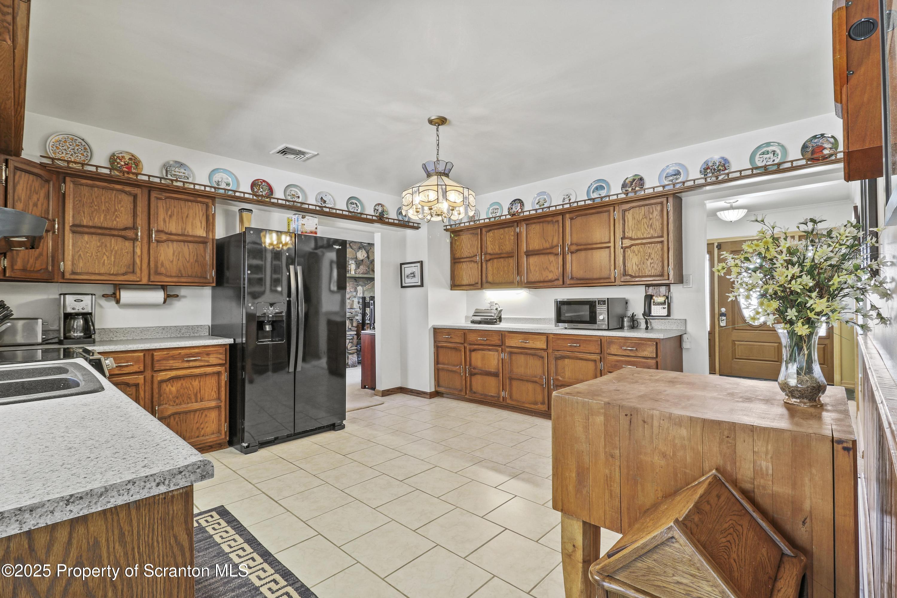 337 Ross Road Dalton, PA 18414 - Photo 8 of 45 a kitchen with stainless steel appliances kitchen island granite countertop a refrigerator and a stove top oven