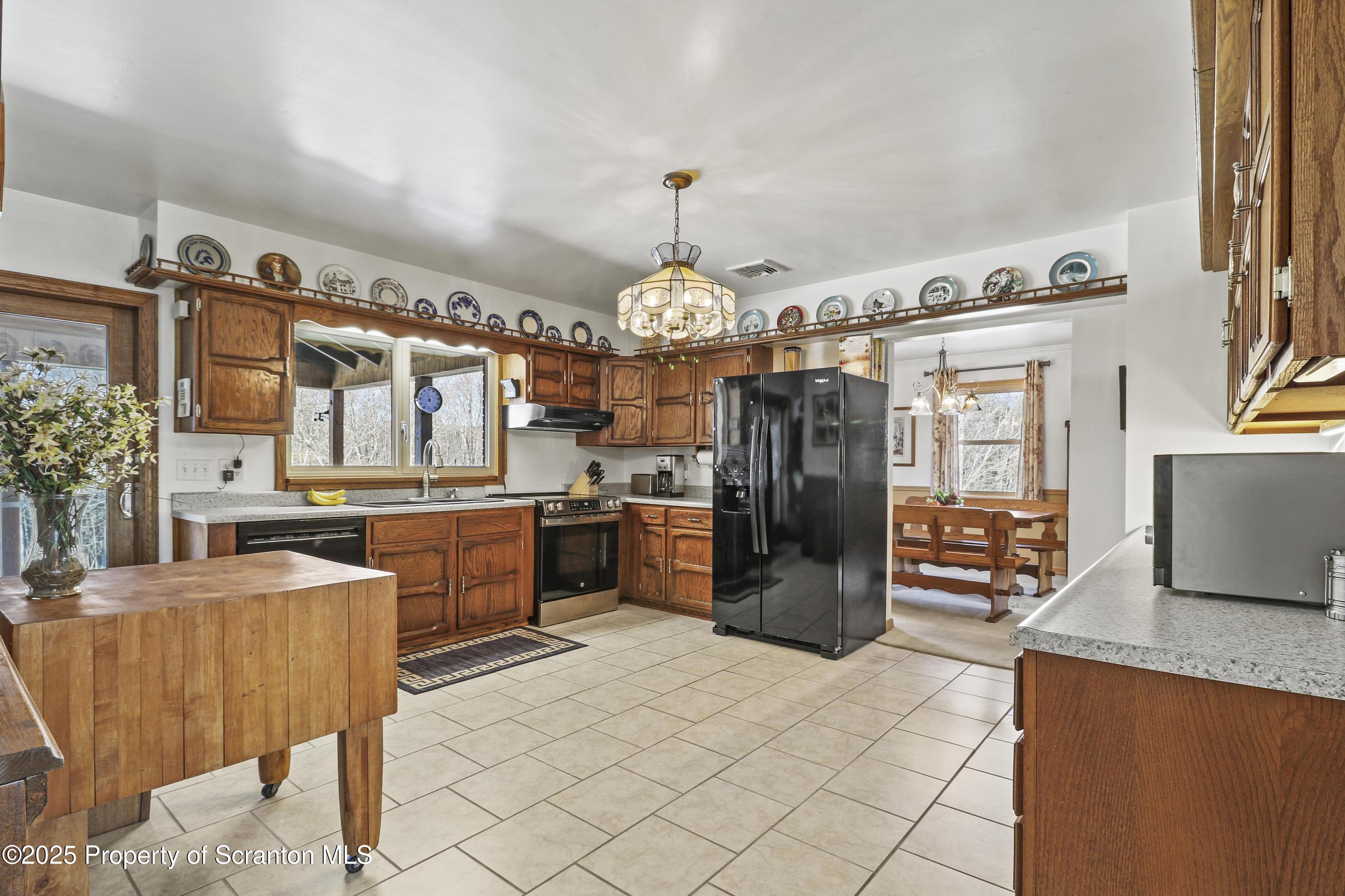 337 Ross Road Dalton, PA 18414 - Photo 9 of 45 a kitchen with refrigerator and cabinets