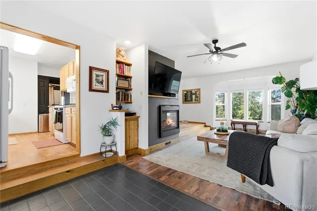 a living room with fireplace furniture and a flat screen tv