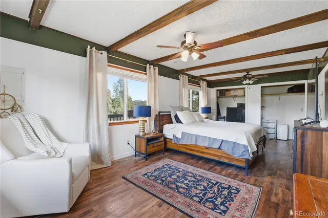 a bedroom with a bed a couch and dresser