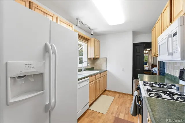 a kitchen with a stove and a refrigerator