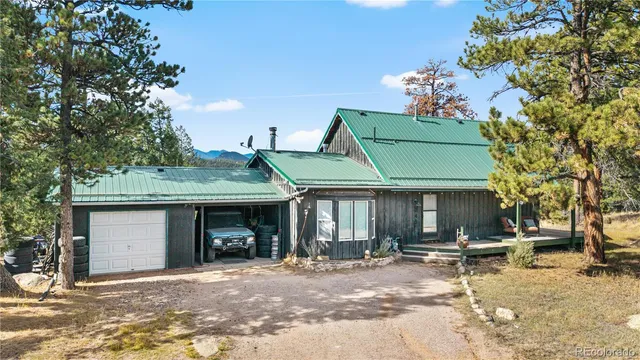 a view of a house with a patio and a yard