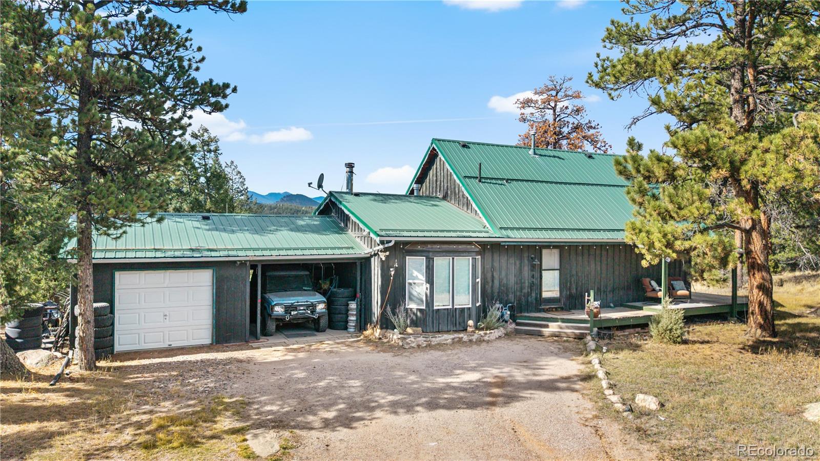243 Hi Meadow Drive Bailey, CO 80421 - Photo 2 of 37 a view of a house with a patio and a yard