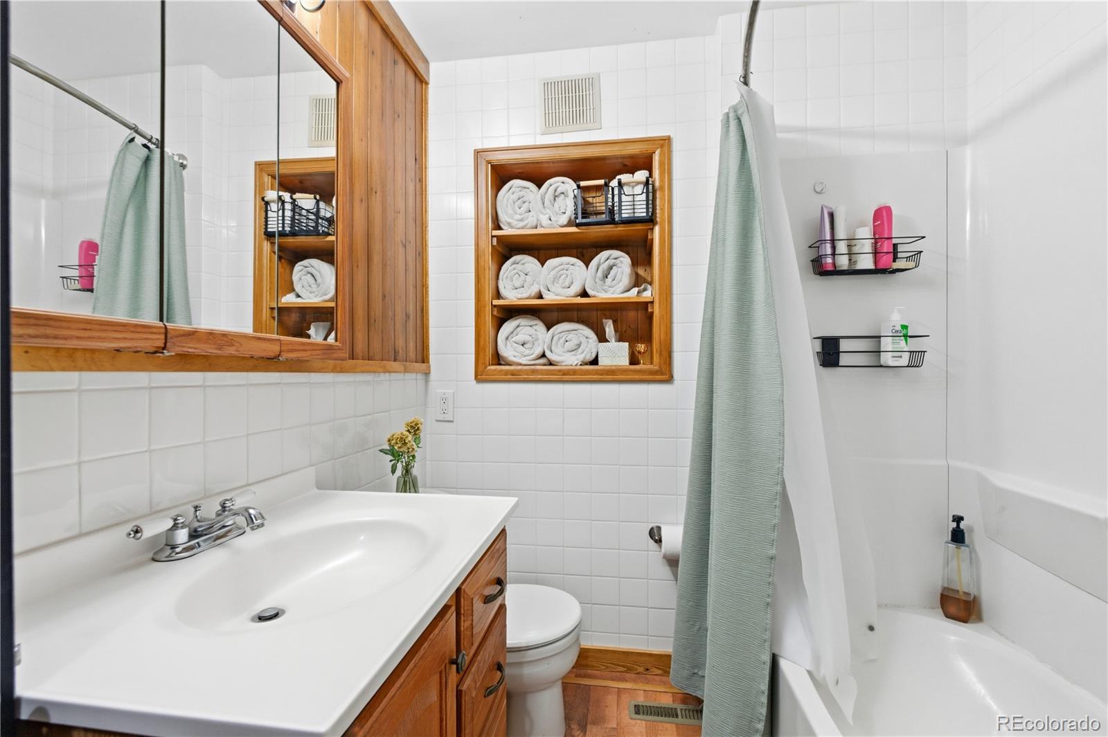 243 Hi Meadow Drive Bailey, CO 80421 - Photo 21 of 37 a bathroom with a sink a toilet and shower curtain