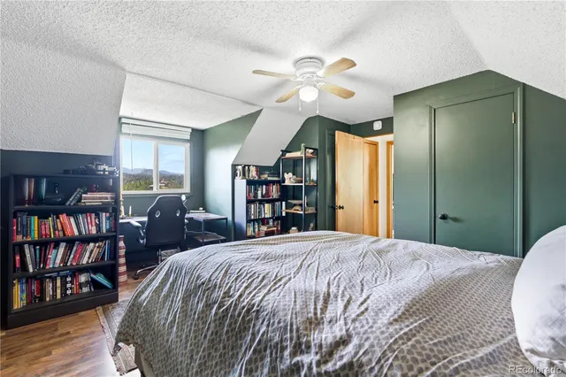 a bedroom with a large bed and a chandelier