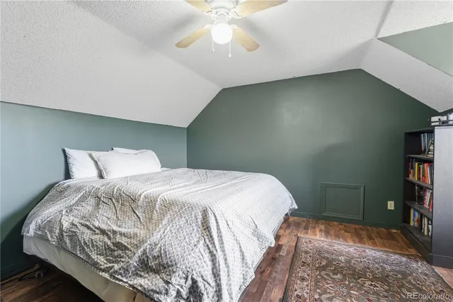 a bedroom with a bed and a book shelf
