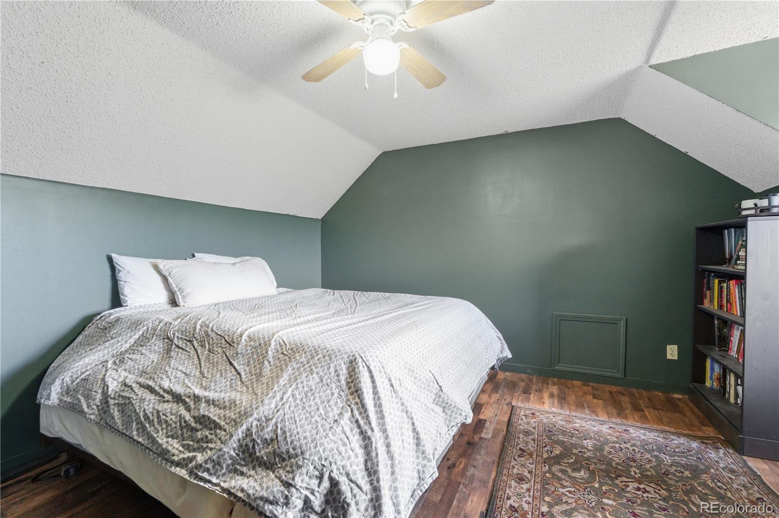243 Hi Meadow Drive Bailey, CO 80421 - Photo 25 of 37 a bedroom with a bed and a book shelf