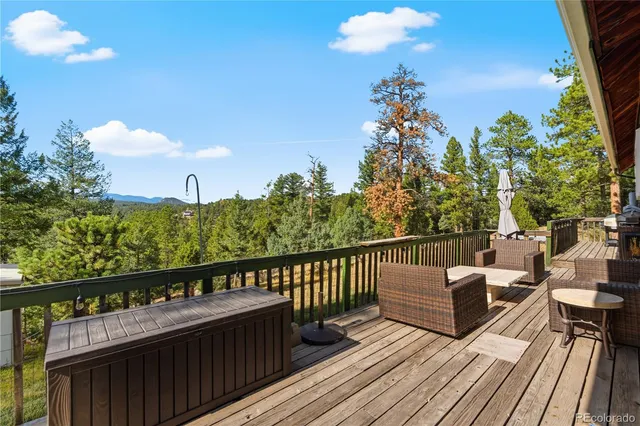 a view of a balcony with wooden floor and outdoor seating