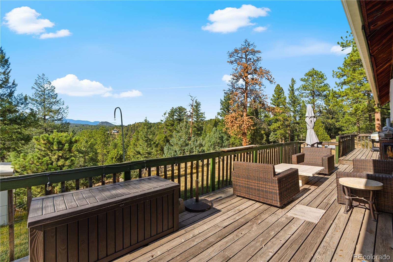 243 Hi Meadow Drive Bailey, CO 80421 - Photo 27 of 37 a view of a balcony with wooden floor and outdoor seating