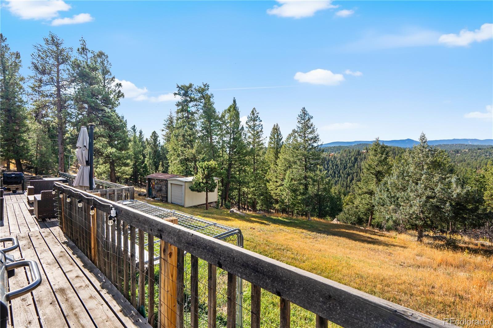 243 Hi Meadow Drive Bailey, CO 80421 - Photo 28 of 37 a view of a balcony with wooden fence and floor